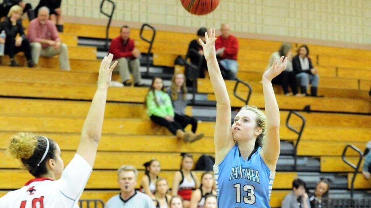 Panther Creek's Cassie Zietlow (13) shoots over Middle Creek's Makayla Patrick (40) during the girls basketball game, which was played in Apex on Thursday, January 28, 2016. Panther Creek won 58-33.