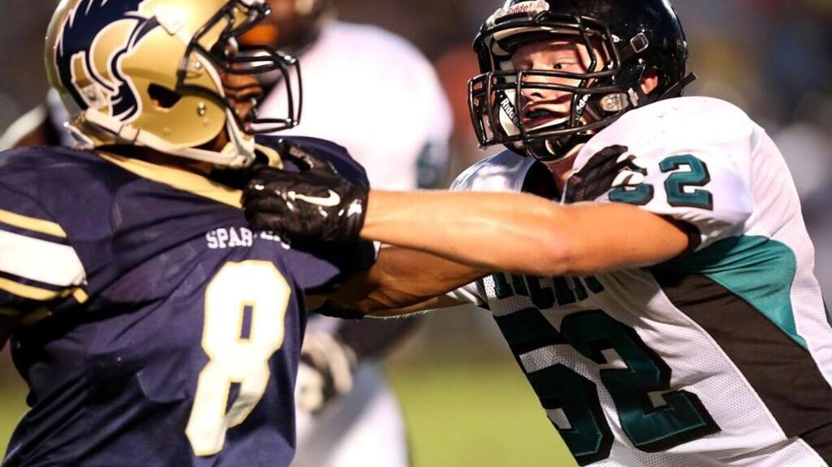
West Johnston's Josh Long (52) tackles Smithfield-Selma's CJ Turner (8) for a lost during the West Johnston High School football game against Smithfield-Selma High School, August 21, 2015 in Smithfield, N.C. West Johnston won 48-7.
