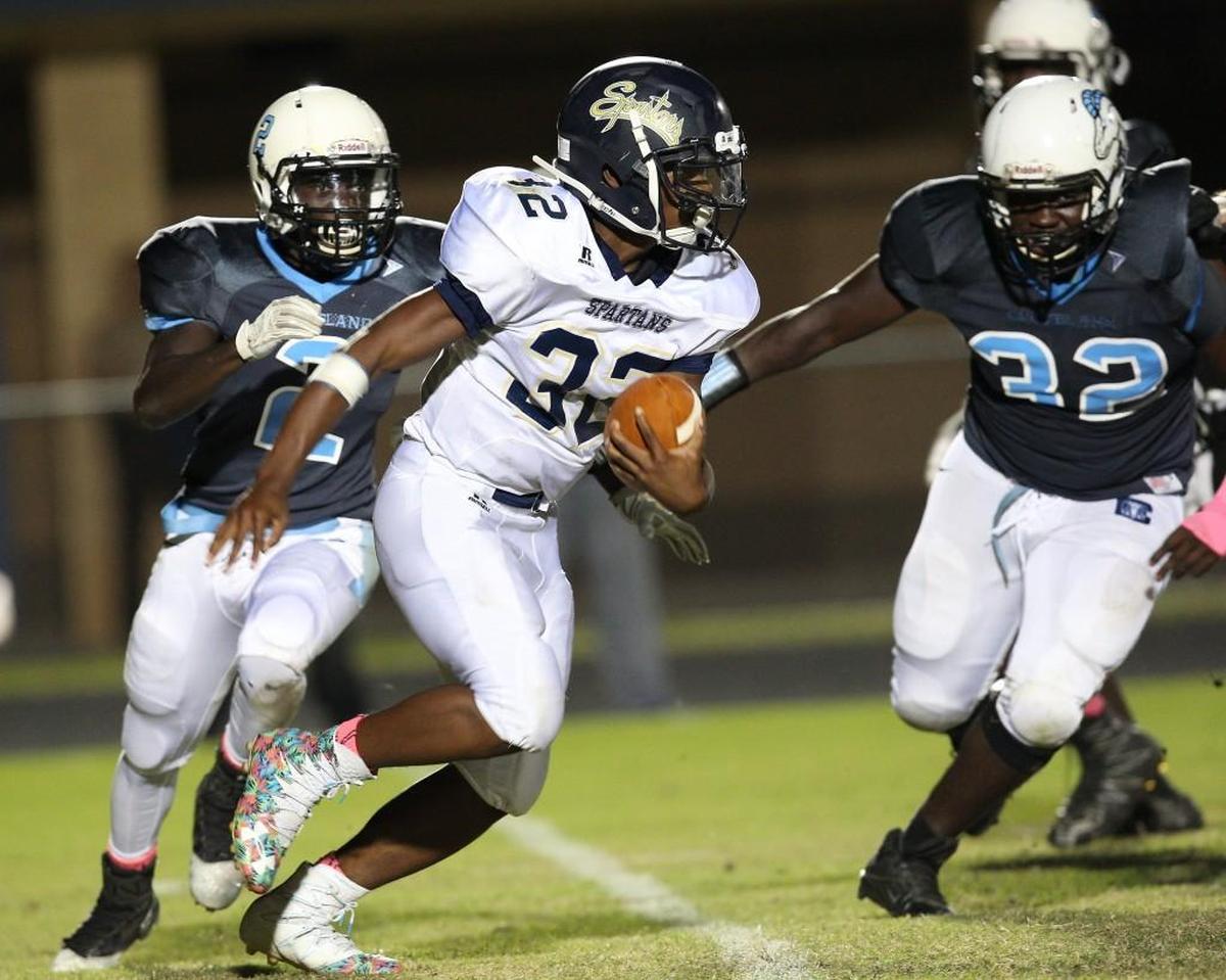 Smithfield-Selma's Demonte Morrison (32) sweeps right as Smithfield-Selma's Terrek Frazier (2)is in prusuit during the Cleveland Rams high school football game with the Smithfield-Selma Spartans high school on September 13, 2016, in Clayton , N.C. Cleveland leads at the half 49-0
