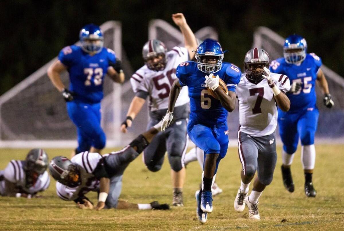 Wake Forest's Marquis Dunn (6) breaks away from the Wakefield defense during a high school football game in Wake Forest, N.C. on Thursday, Oct. 6, 2016.