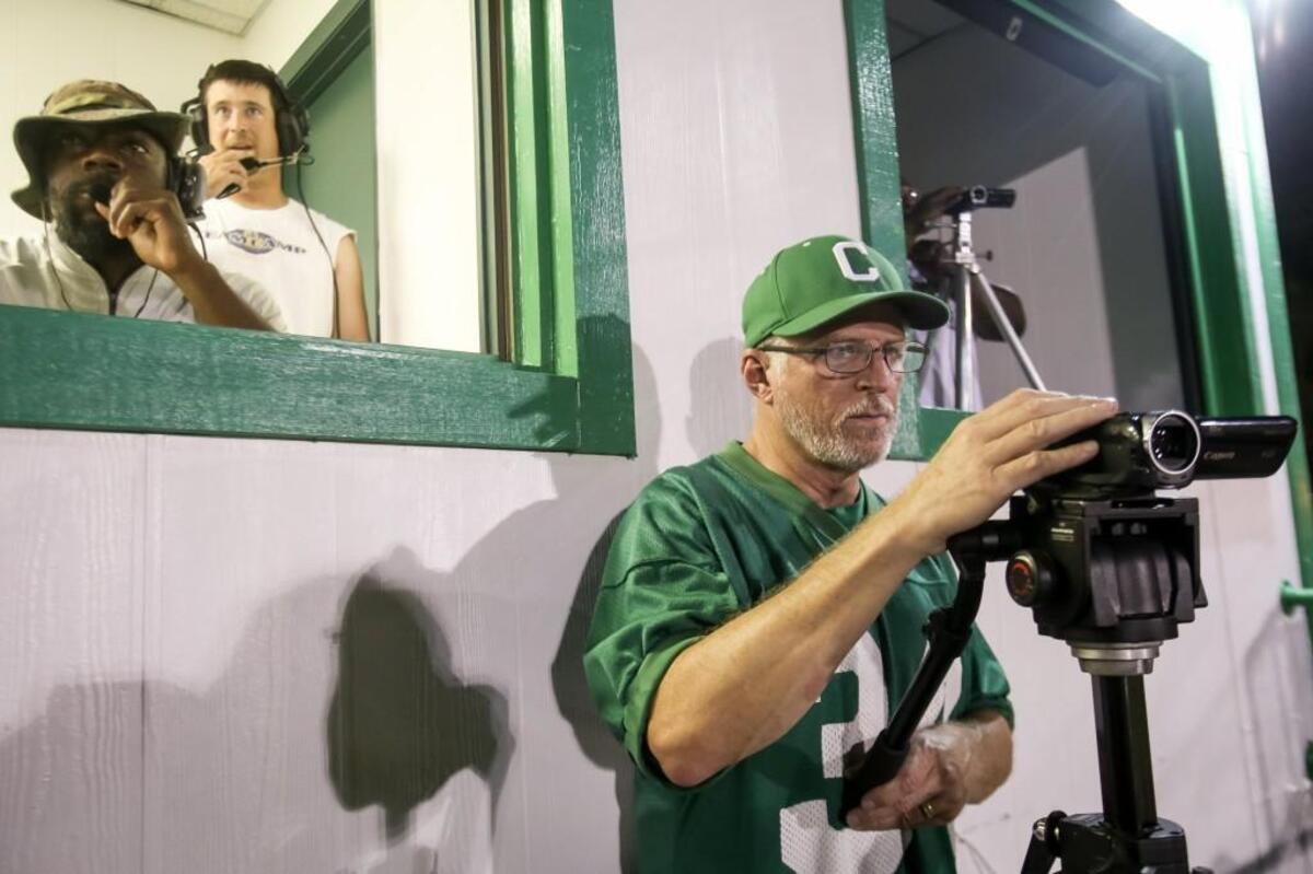 Darryl Rodgers, whose son Justin plays defensive back for Cary, records the game from just outside the press box during Cary's season-opening win on Friday, August 18, 2017.