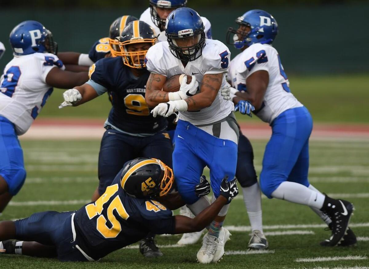 Fred Harris (5) of Person carries the ball against a tackle from Anthony Freeman (45) of Northern. The Northern Knights played the Person Rockets in a football game that took place in Durham, N.C. on Friday, August 26 2017.