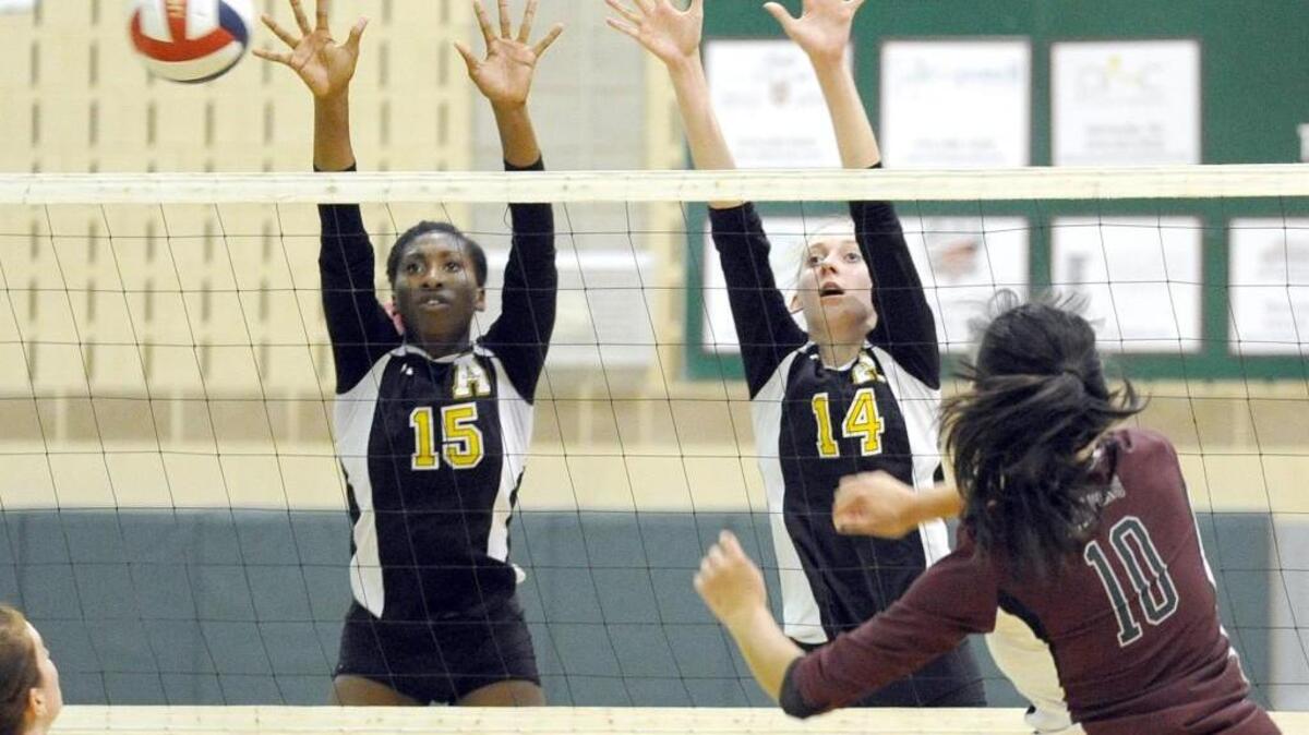 
Green Hope’s Amy Zhang (10) hits the ball past Apex's Breanna Andrea (15) and Madeline Rudd (14) during the volleyball match on Thursday, October 8, 2015 in Cary. Apex won 3-1.
