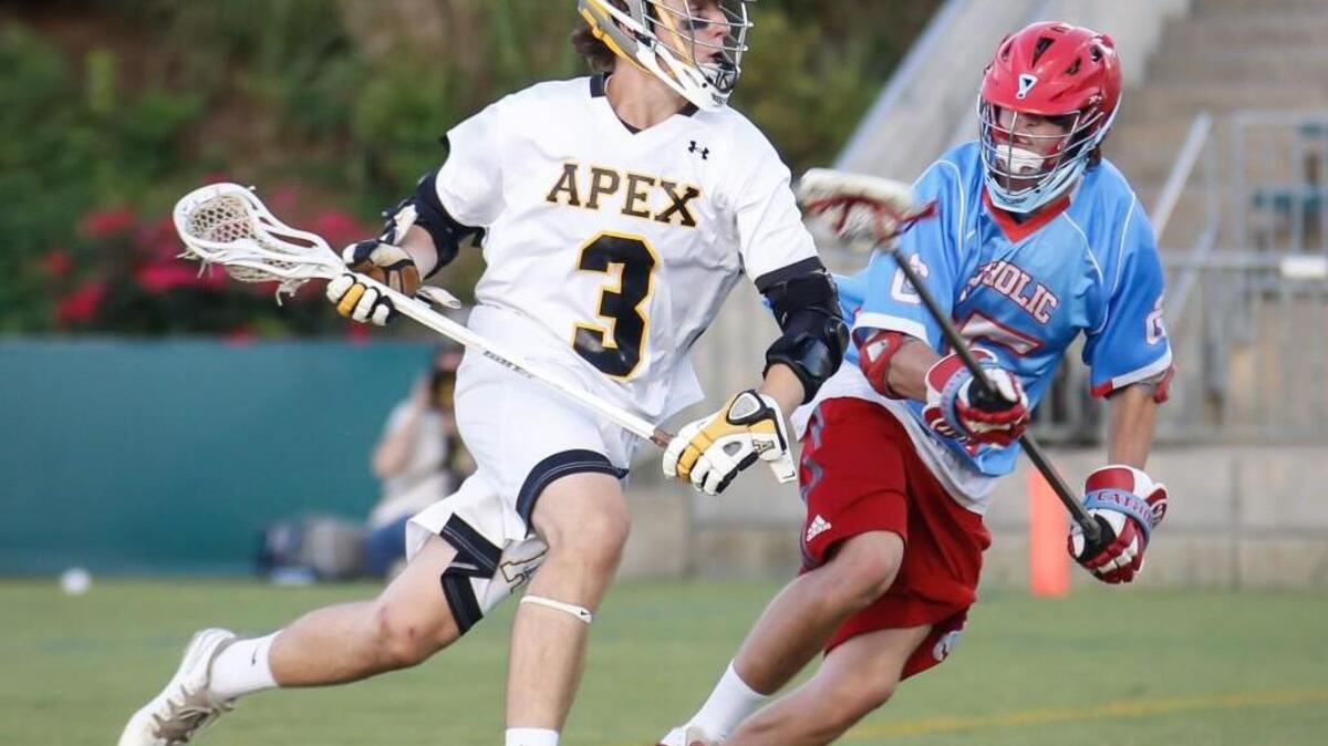 Apex's Jack Hayden (3) sprints past Charlotte Catholic's Dan Crotty (35) during the NCHSAA 4A state lacrosse championship between Apex and Charlotte Catholic on Friday, May 22, 2015.
