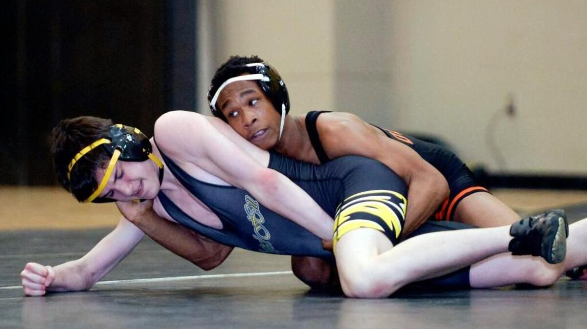Hakeem Jones, right, of Orange, grabs hold of Chapel Hill’s Jack Davenport in a 132-pound match on Wednesday.