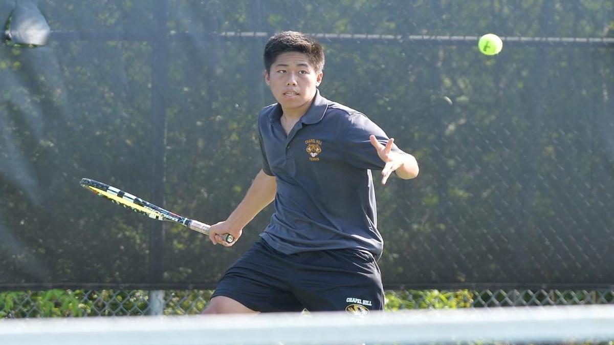 Paul Tsui of Chapel Hill hits the ball during his singles game against Blake Deaton of Union Pines. The Chapel Hill Tigers played the Union Pines Vikings in a boys tennis match that took place in Chapel Hill, N.C. on Wednesday, May 10 2017. Chapel Hill won 5-4.