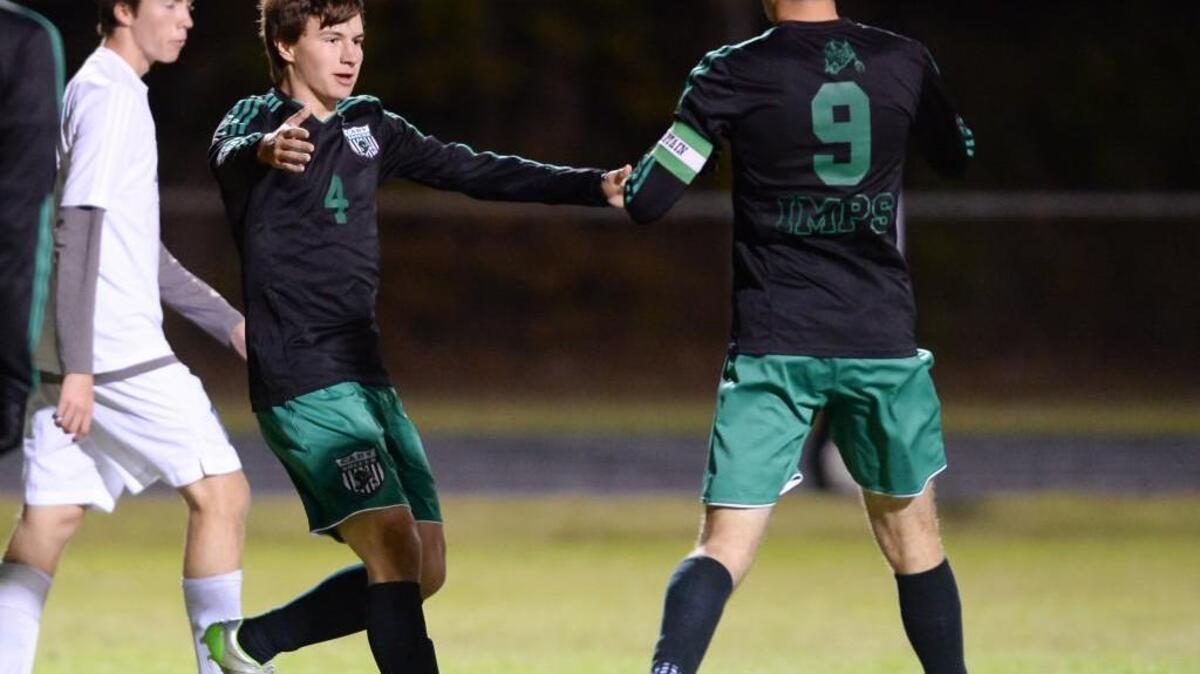 
Quinn Dunphy (4) of Cary celebrates the third goal for the Imps along his teammate George Bournazian (9). The Cary Imps played the Athens Drive Jaguars in Raleigh, N.C. on Monday, October 19, 2015. Cary won 4-2.
