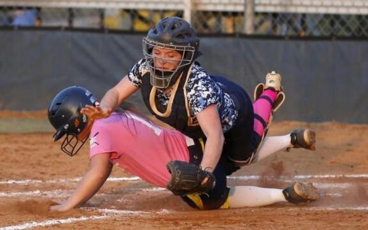 D.H. Conley's Madison Bowers (1) slides safe at home as C.B. Aycock's catcher Taylor Puetz (8) attempts to catch the throw during the C.B. Aycock High School girl's softball game against D.H. Conley High School in Greenville, N.C. on Tuesday, March 21, 2017.