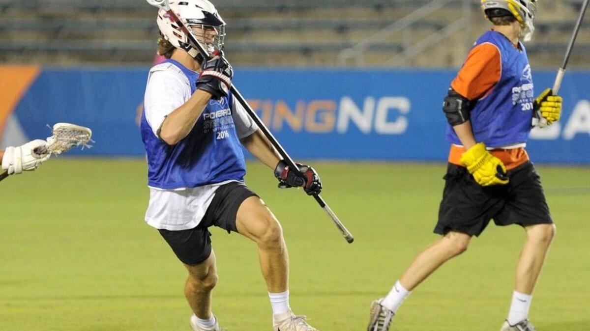 East's Jack Biestek handles the ball against West during the Powerade State Games lacrosse match, which was played on Thursday, June 23, 2016 in Cary. West was ahead 3-2 when the game was cancelled in the second quarter due to weather.