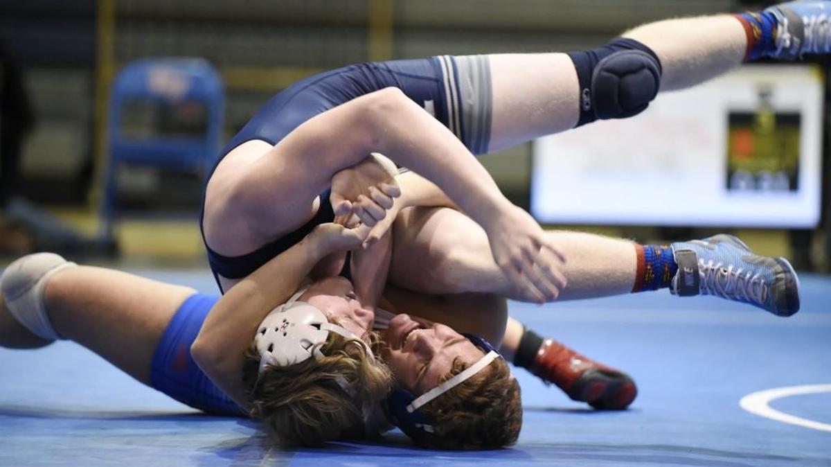 Wake Forest's Joshua Cathcart and Millbrook's Jacob High compete in the 220 pound weight class at a playoff wrestling match in Wake Forest, N.C. on Tuesday, February 2, 2015. Cathcart won the match.