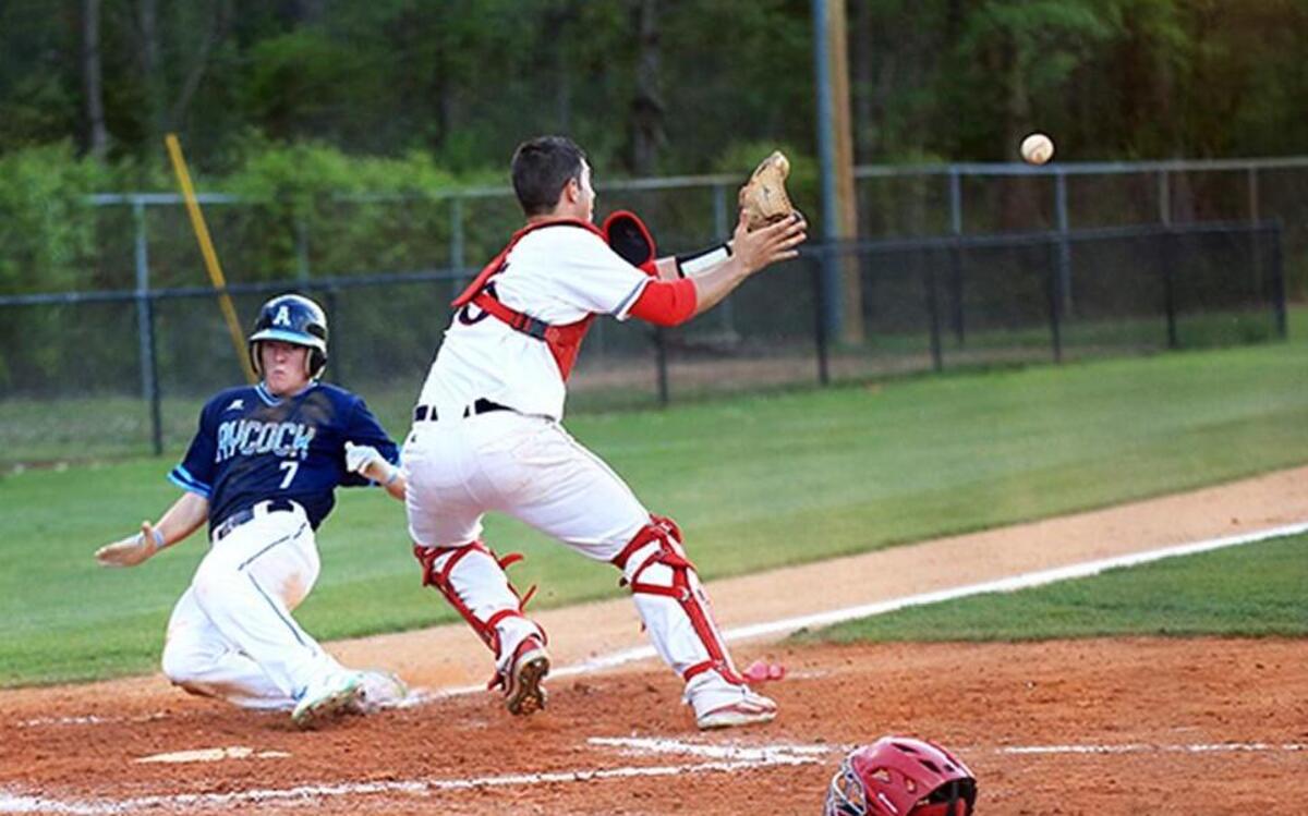 Aycock's Kolby Anderson slides home while Southern Wayne's Kolby Anderson receives the throw during the CB Aycock at Southern Wayne Baseball game on Apr 11, 2017.