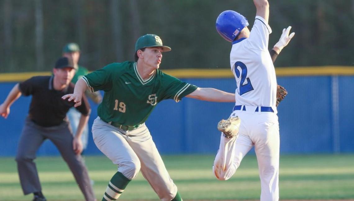 South Johnston first baseman Grant Millay (19) comes off the bag to make the tags on Jacob Maness (2) as he runs down the first base line. Coverage from the prep baseball game between the South Johnston Trojans and the Triton Hawks played in Erwin, N.C. on Tuesday, March 28, 2017. South Johnston defeated Triton by a score of 15-4.