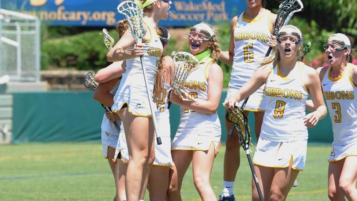 Cardinal Gibbons celebrates Jordan Lappin's goal, which sent the game into overtime during the NCHSAA girls lacrosse championship game between the Lake Norman Wildcats and the Cardinal Gibbons Crusaders, which was played on Saturday, May 23, 2015 in Raleigh. Lake Norman won 17-15 in overtime.