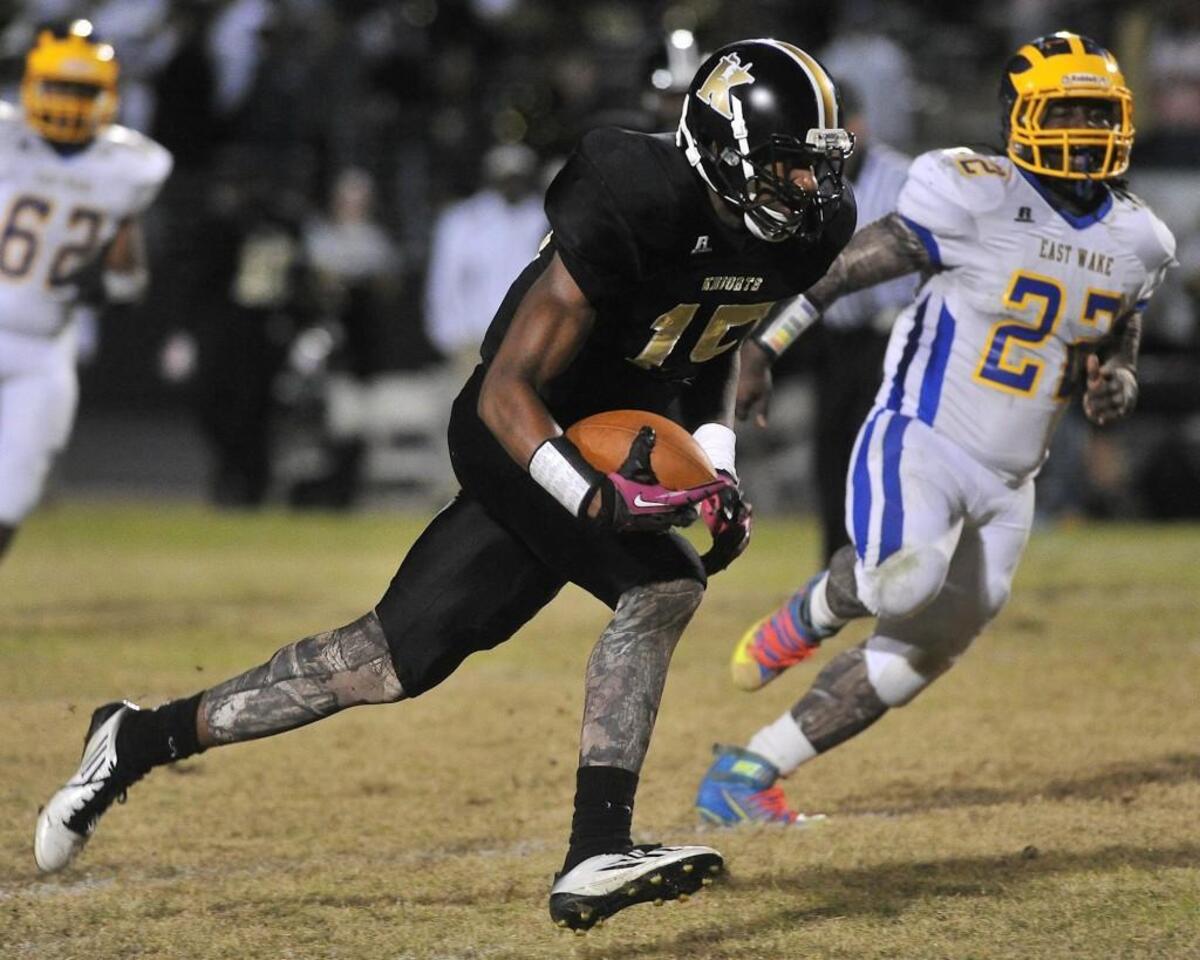 Knightdale’s Drew Tuazama (15) runs for yardage while pursued by East Wake’s Mikekale Engles (22) during their game in Knightdale Oct. 30, 2015.