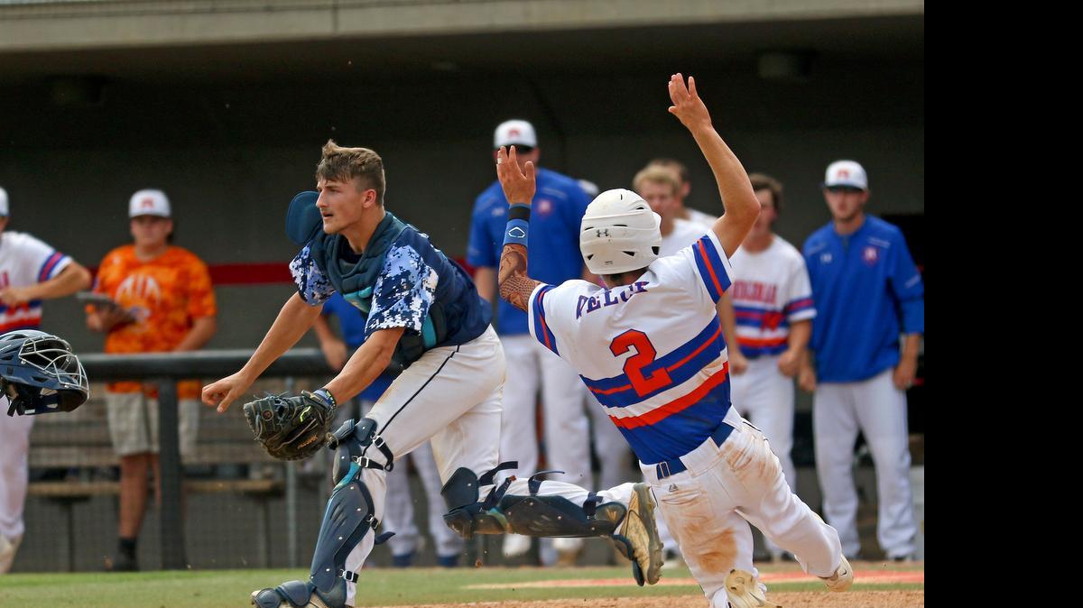 
South Granville catcher Ty Adcock awaits the throw as Randleman baserunner Baily Welch (2) makes it to the plate safely in the explosive 5th inning. The Tigers of Randleman High defeated the Vikings of South Granville High School 11-1 in five innings in Game 2 to even the series 1-1 played at N.C. State's Doak Field in Raleigh N.C. on Saturday, June 6, 2015.

