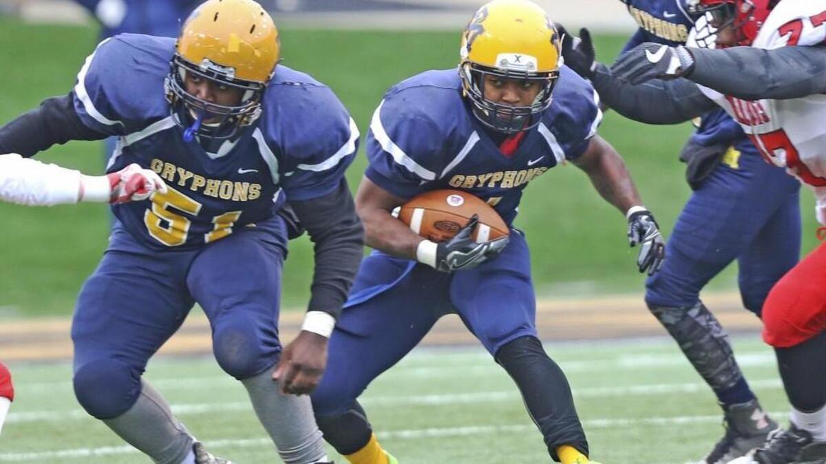 Rocky Mount's B.J. Sanders (1) runs behind the blocking of Jalon Hill (51) as South Point's Philip Davis (77) closes in on the tackle. Coverage from the 3A NCHSAA Championship football game between the Rocky Mount Gryphons and the South Point Red Raiders played at BB&T Field, Winston-Salem, N.C on Saturday, December 17, 2016. South Point defeated Rocky Mount 16-7 to win the 3A State Football Championship.