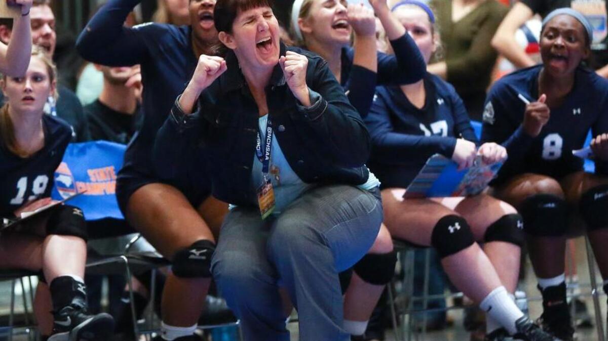 South Granville coach Christy Fitzgerald and the bench react to the final point and a state championship. Coverage of the 2A NCHSAA State Championship Volleyball Tournament Finals between the South Granville Vikings and the Wheatmore Warriors played at the Raleigh Convention Center on Saturday, November 7, 2015. South Granville won 3-2.