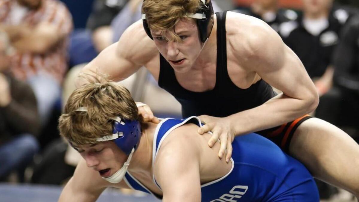 Orange's Joe Scott, top, wrestles against Asheboro's Sawyer Davidson, losing their 3A 152-pound championship match 8-4 to finish second in the state, during the NCHSAA State Wrestling Championships in Greensboro on Saturday, February 20, 2016.