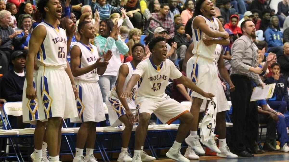Garner's bench clears the seats after a Garner dunk during the Garner Trojans high school basketball game with the Durham Pirates in 4A Boys Basketball Playoffs, Saturday, February 27, 2016, in Garner, N.C. Garner won 92-74.