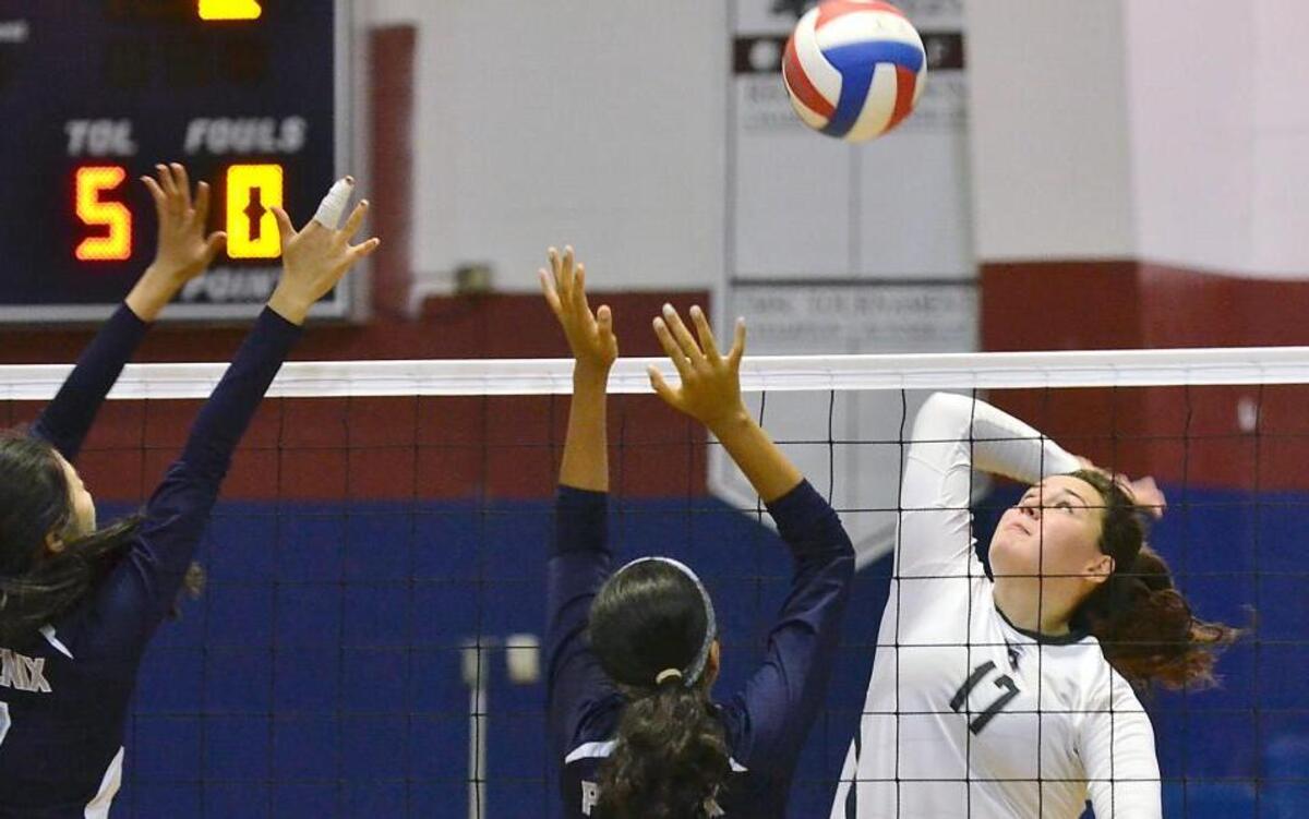 East Wake Academy’s McKenzie Alford (17) prepares to strike the ball while Raleigh Charter’s Ashmi Dagar (11) and Sophie Sun (7) defend. The East Wake Academy Eagles hosted the Raleigh Charter Phoenix for a North Central Athletic 1A Conference volleyball match in Zebulon, N.C. Thursday, Sept. 22, 2016. East Wake Academy won, 3-1.