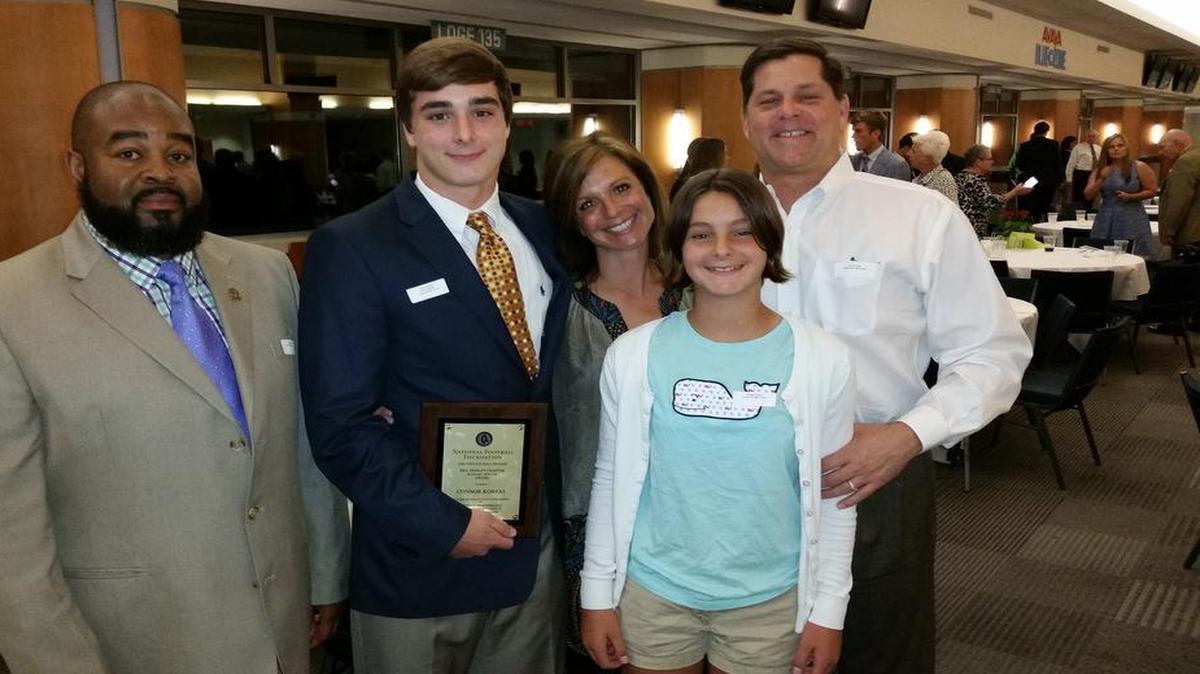 Chapel Hill High School all-conference safety Connor Korfas, second from left, was recognized as a High School Scholar-Athlete by the Bill Dooley Chapter of the National Football Foundation during ceremonies Monday at UNC’s Kenan Stadium. Korfas has commited to play nexty fall at Denison. From left to right: Chapel Hill football head coach Issac Marsh; Connor Korfas; his mother, Anne; sister Morgan; and his father James Korfas.