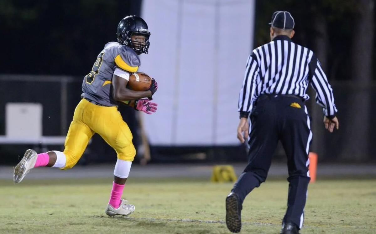 
Albert Nyamayaro (9) of Chapel Hill runs for the first of his two touchdowns Friday night after receiving a pass from Connor Stough. The Chapel Hill Tigers played the Northern Vance Vikings in Chapel Hill, N.C. on Friday, October 16, 2015.
