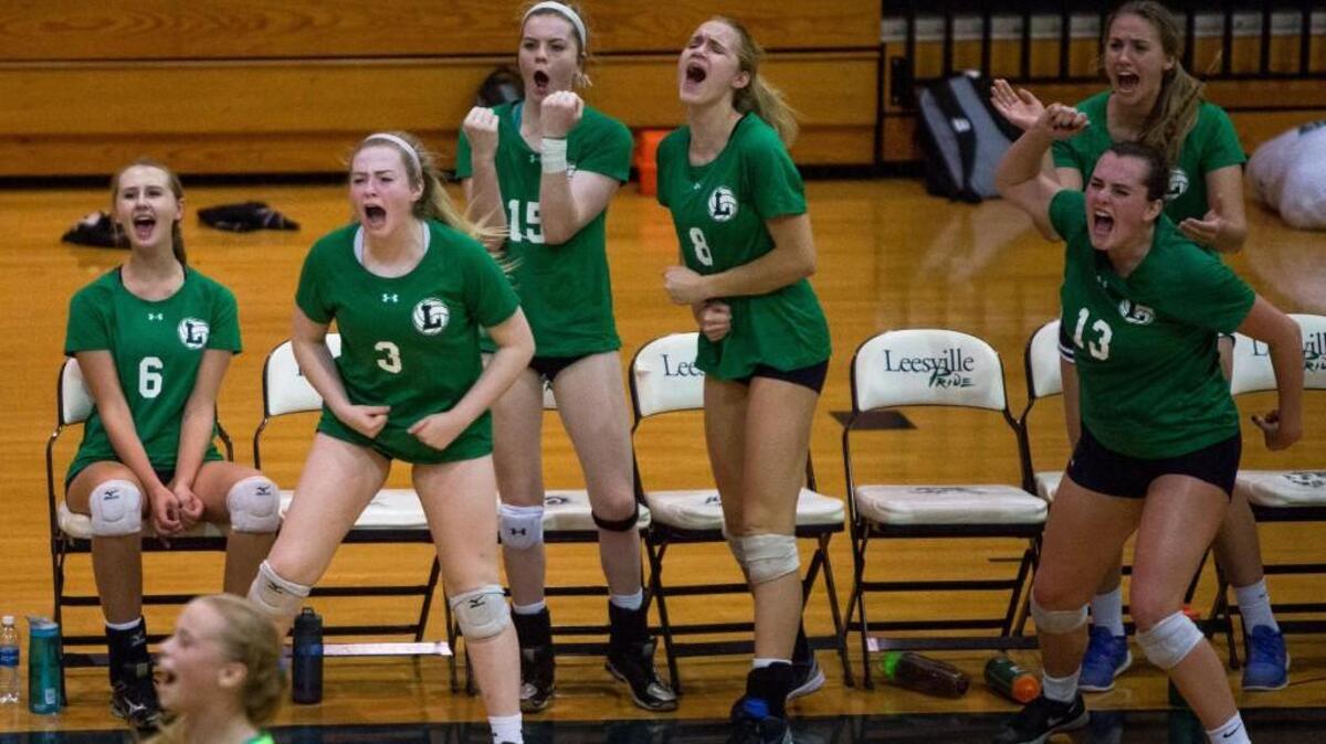 The Leesville Road girls volleyball team celebrates following a point during a high school volleyball game against Broughton in Raleigh, N.C. on Thursday, Sep. 15, 2016.