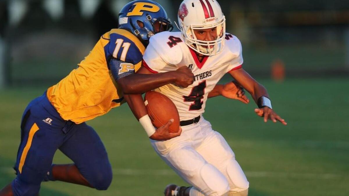 North Johnston's Trey Whitley (4) pulls away from Princeton's Chris Edmundson (11) during the Princeton High school football game with the North Johnston High School on September 9, 2016, in Princeton, N.C.