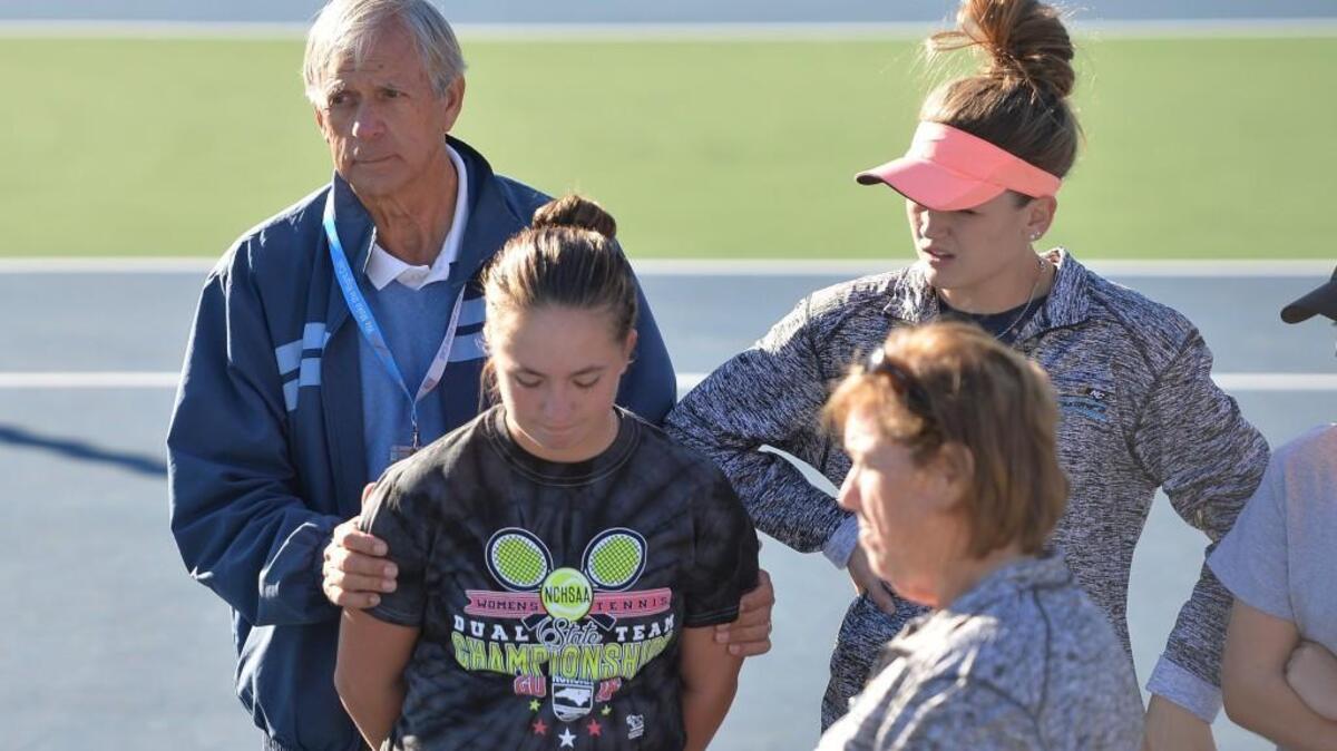 John Frye, left, head coach of Union Pines consoles his players at the end of the women dual team tennis games between the Union Pines Vikings and the Marvin Ridge Mavericks that took place at the Burlington Tennis Center in Burlington, N.C. on Saturday, November 12, 2016.