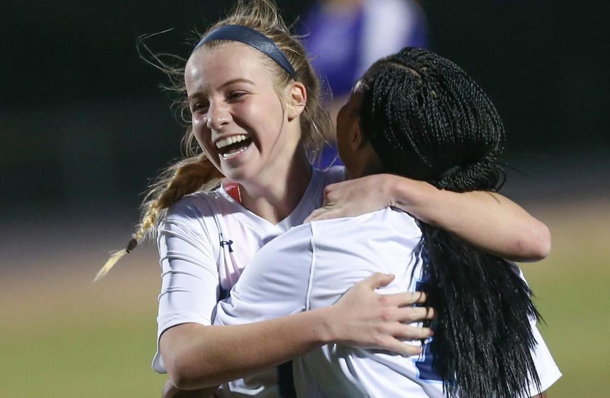 Millbrook's Lexie Strickland (left) is congratulated by teammate Makaya Parham (7) after tying the game in the 57th minute. Coverage from the prep soccer game between the Millbrook Wildcats and the Broughton Captials played in Raleigh, N.C. on Monday, March 20, 2017. Millbrook defeated Broughton 3-2 for the win.