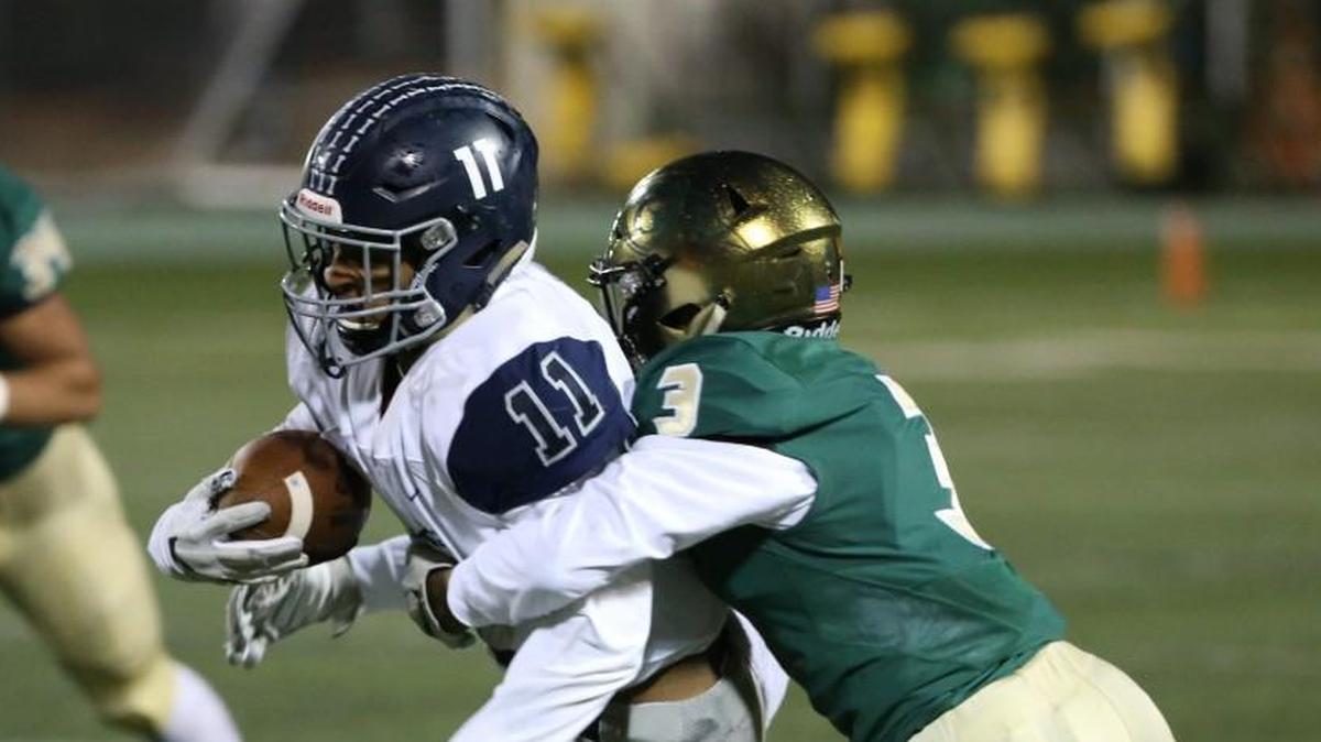 Heritage's Devin Grant (11) gains yardage as Cardinal Gibbon's Trey Mason (3) hangs on.The Cardinal Gibbons Crusaders football team has a home 2nd round playoff game vs. Heritage Huskies on Friday, November 17, 2017. Raleigh ,N.C.