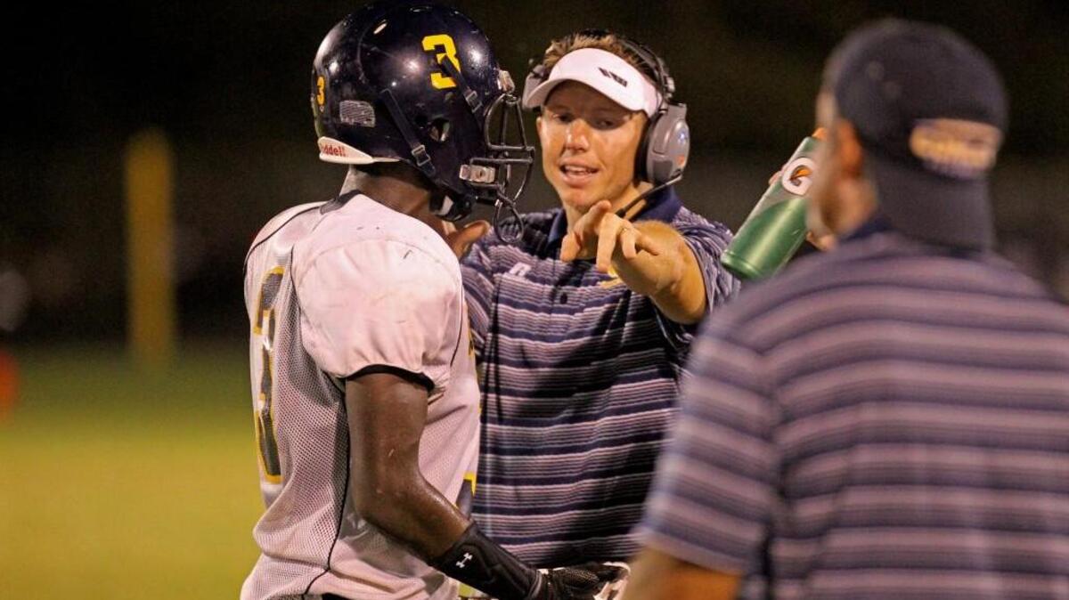 D.H. Conley coach Nate Conner talks with linebacker Jazion Daniels (3) on the sideline during the first half of the football game against J.H. Rose in Greenville, N.C. on Friday, September 23, 2016.