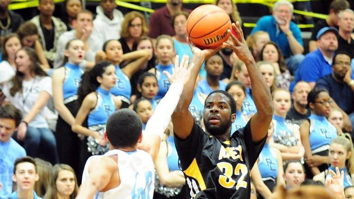 Apex’s Ian Boyd (32) shoots over Panther Creek's Juan Munoz (40) during the boys basketball game, which was played on Thursday, December 17, 2015 in Cary.