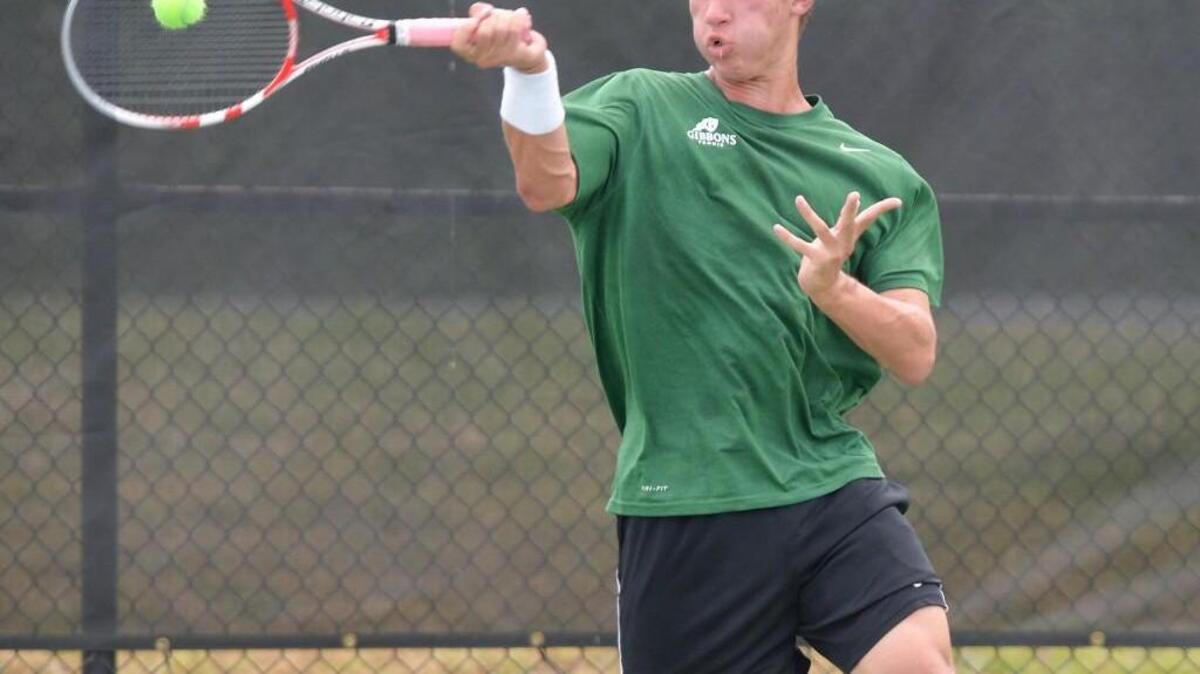 Jim Mantyh of Cardinal Gibbons hits a return against Jim Hatala of Marvin Ridge. The Cardinal Gibbons Crusaders played the Marvin Ridge Mavericks in the final dual team men tennis match that counted for the 3A NCSHAA State Championship in Burlington, N.C. on Saturday, May 16, 2015. Marvin Ridge won 5-4.