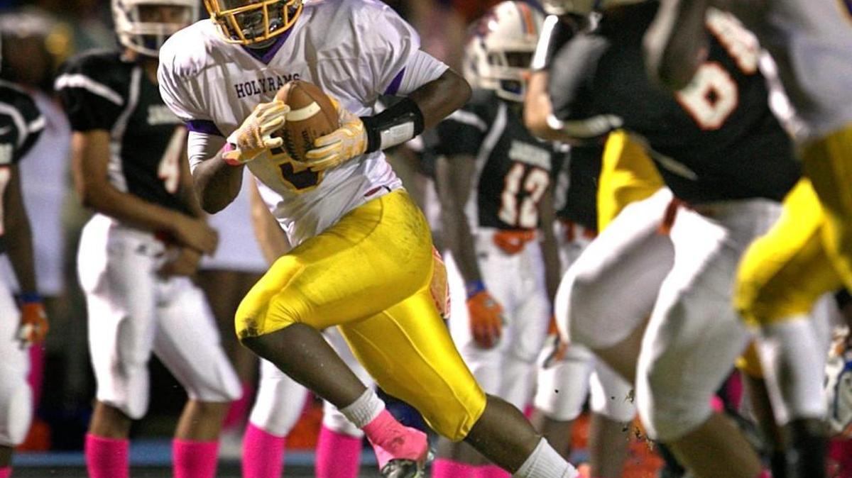 
Word of God's NyQuan Williams (5) intercepts a pass by Athens Drive quarterback Tre Echols (8) to set up the Ram's third touchdown in the first quarter at Athens Drive High School on Friday, October 9, 2015 in Raleigh, N.C.
