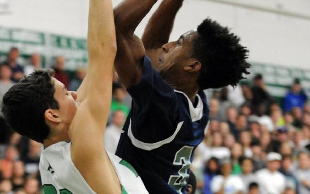 Leesville's Alex Hunter (3) drives to the basket through Cary's Philip Blackley (20) during the third round NCHSAA 4A playoff game, which was played in Cary on Saturday, February 27, 2016. Cary won 54-50.