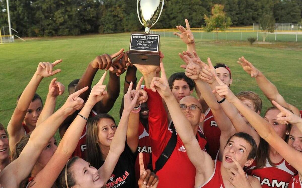 
The Rolesville Rams host up their trophy after winning the Greater Neuse River boys cross country championship. The Greater Neuse River Conference held its boys and girls cross country championships at Wendell Park in Wendell, N.C. on October 14, 2015.
