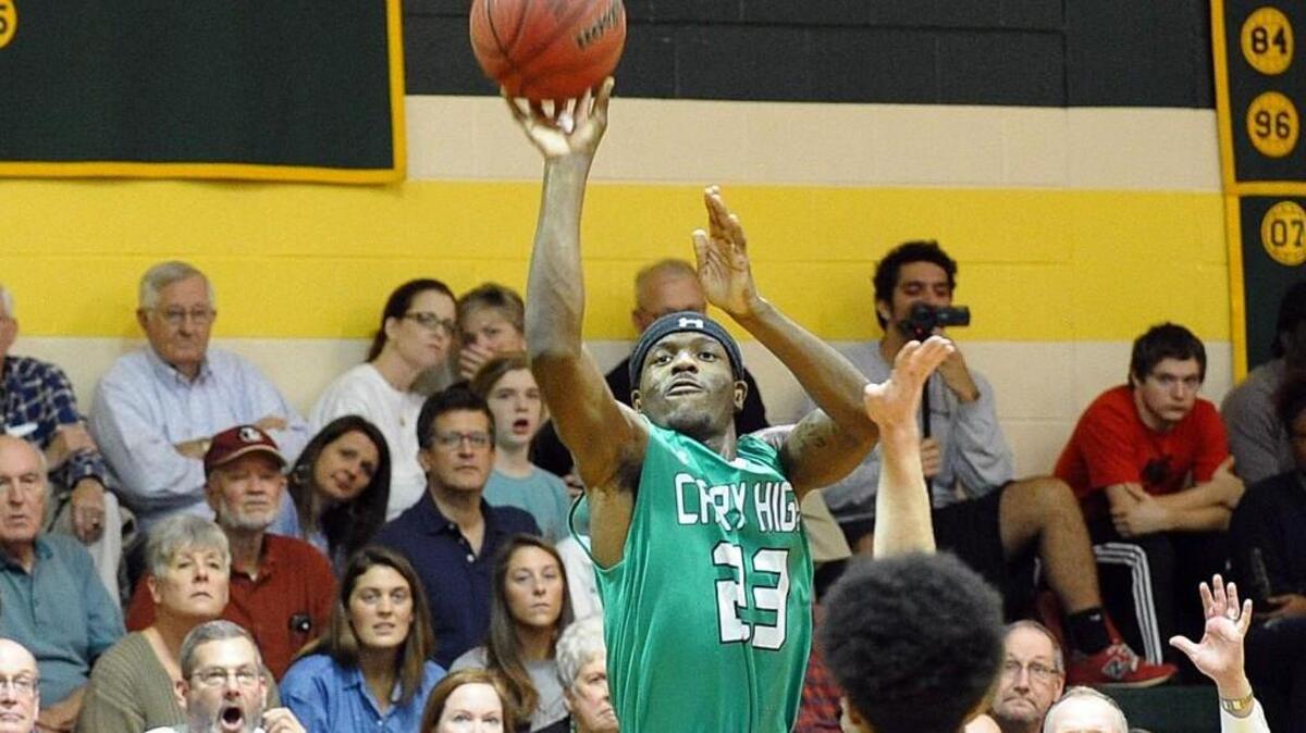 Cary's Donte Tatum (23) takes a perimeter shot against Apex during the boys basketball game, which was played in Apex on Friday, January 13, 2017.