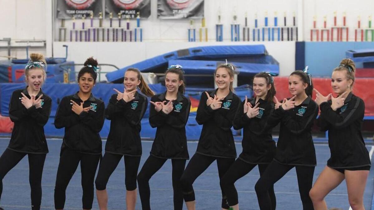 West Johnston's team pose for a picture after the last rotation, from left to right, Carleigh Chapman, Samantha Griffin, Alexa Baggett, Tasha Brozowski, Jessica Walker, Lelia Brozowski, Sarah Ford and Abigayle Harrison. North Carolina High School State Gymnastics Championships took place in Raleigh, N.C. on Saturday, January 27, 2018.
