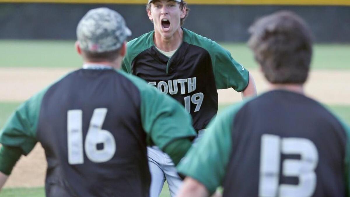 South Johnston’s Grant Millay (19) reacts to the final out in the seventh inning come-from-behind victory to keep the Trojans alive in the playoffs.