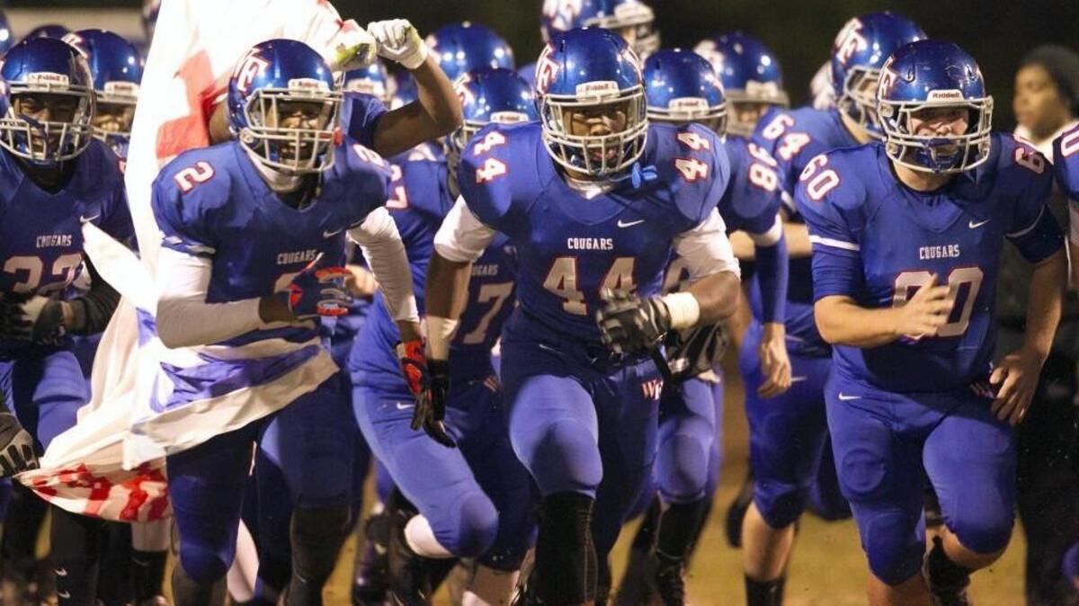 Wake Forest storms onto the field prior to their 23-17 victory over Garner in the east regional championship game on Friday, December 5, 2014 at Wake Forest High School in Wake Forest, N.C.