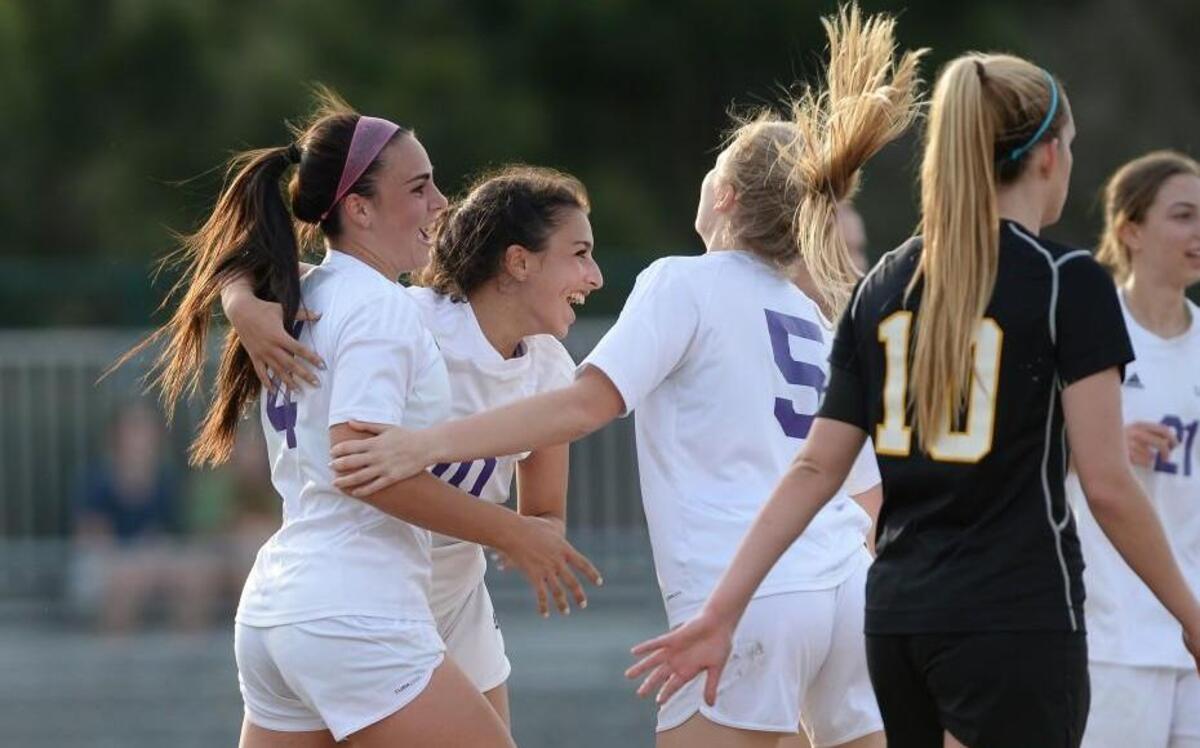 Alexa Wojnovich, left, of Carrboro is congratulated by her teammates Miah Araba, second from left and Lucy Holmes after scoring a goal. The Carrboro Jaguars played the Chapel Hill Tigers in Carrboro, N.C. on Wednesday, March 16, 2016. Chapel Hill won 2-1.