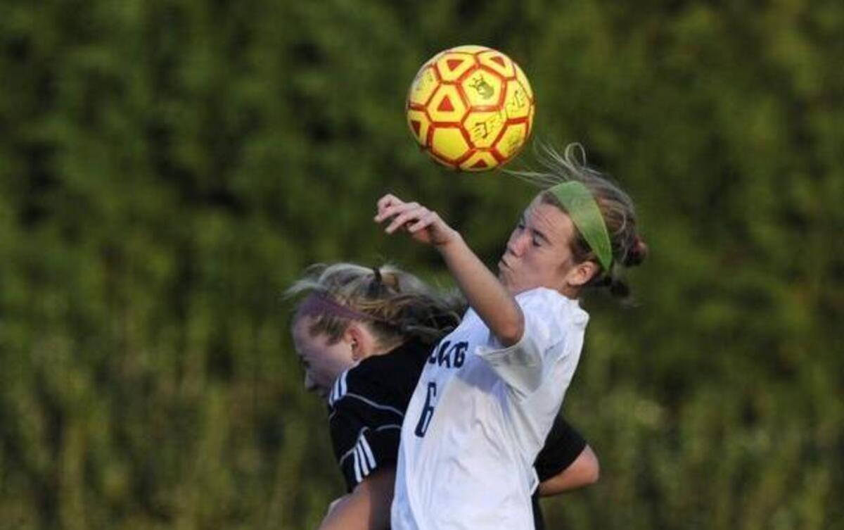 Wakefield's Emma Lanter (15) and Millbrook's Claire Griffiths (6) head the ball in Raleigh, N.C. on Wednesday, March 23, 2016. Millbrook won 1-0.