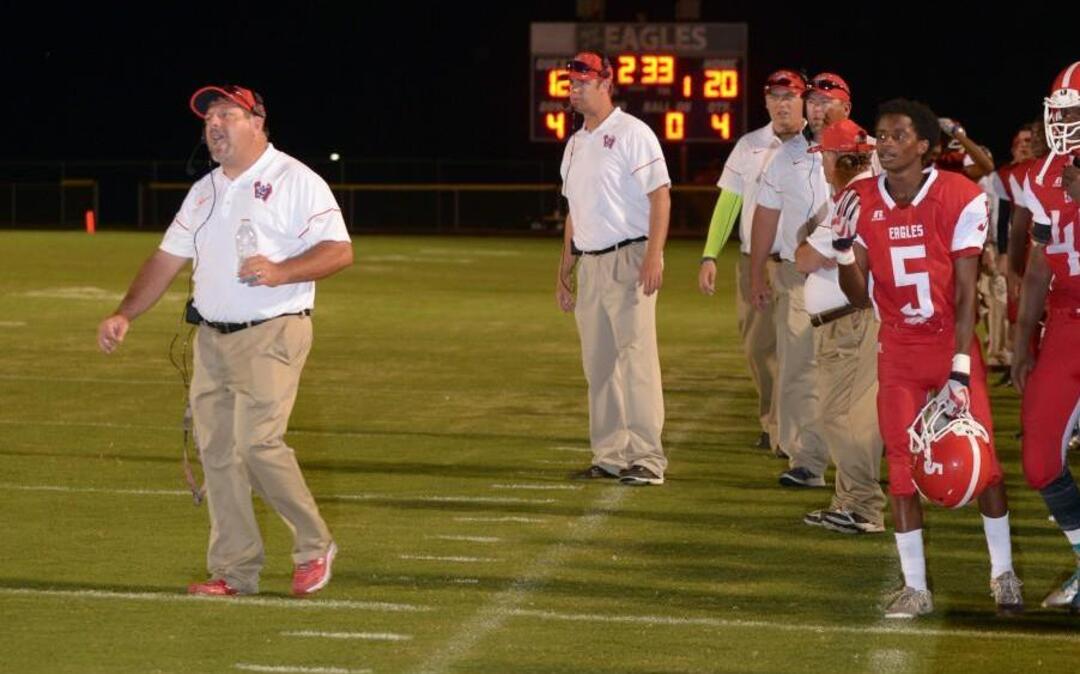 Western Harnett coach Jason Furrie (left) looks onto the field in a football game against Harnett Central on Aug. 26, 2016. The Eagles won the game.