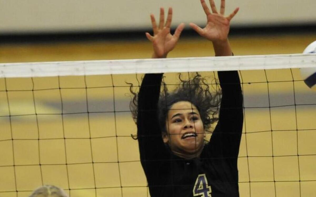 Broughton’s Tiana Butler (4) tries to block a shot by Apex's Jenna Dalbo (7) during their 4A playoff game in Raleigh, N.C. on Tuesday, October 27, 2015. Broughton won 3-0.