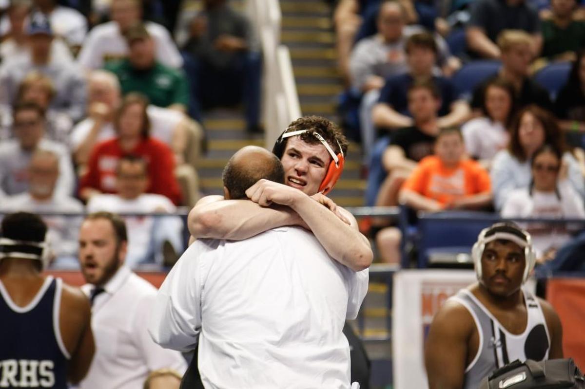 Orange's Payton Wilson celebrates with his coaches after winning the 3A 220-pound group during the NCHSAA Wrestling State Championship in Greensboro on Saturday, February 18, 2017.