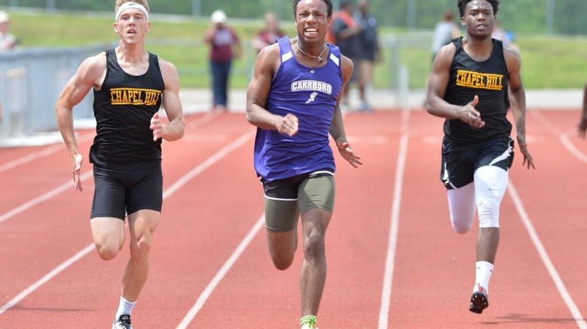 Quinton Adams, center, of Carrboro, Albert Nyamayaro, right, and Harrison Young, left, of Chapel Hill compete in the 200m Dash during the Orange County Track and Field Championships that took place at Cedar Ridge High School in Hillsborough, N.C. on Saturday, April 23, 2016.