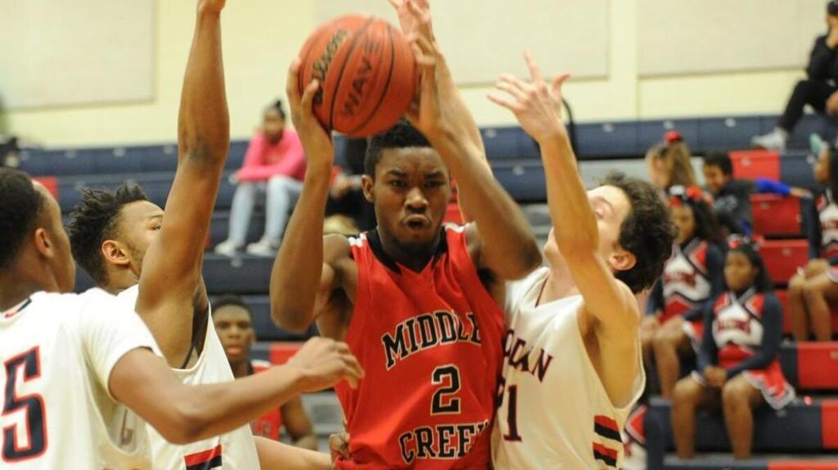 Middle Creek’s Demetrius Bastian breaks through the Jordan defense as he goes to the basket during the first round of the NCHSAA boys basketball tournament, which was played in Durham on Tuesday, February 23, 2016. Middle Creek won 55-47.