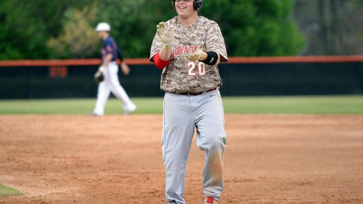 Voyager Academy's designated hitter, Kendall Vincent (20) celebrates with the dugout after a hit. Southern Lee and Voyager Academy play for the Chatlee Invitational Baseball Championship.