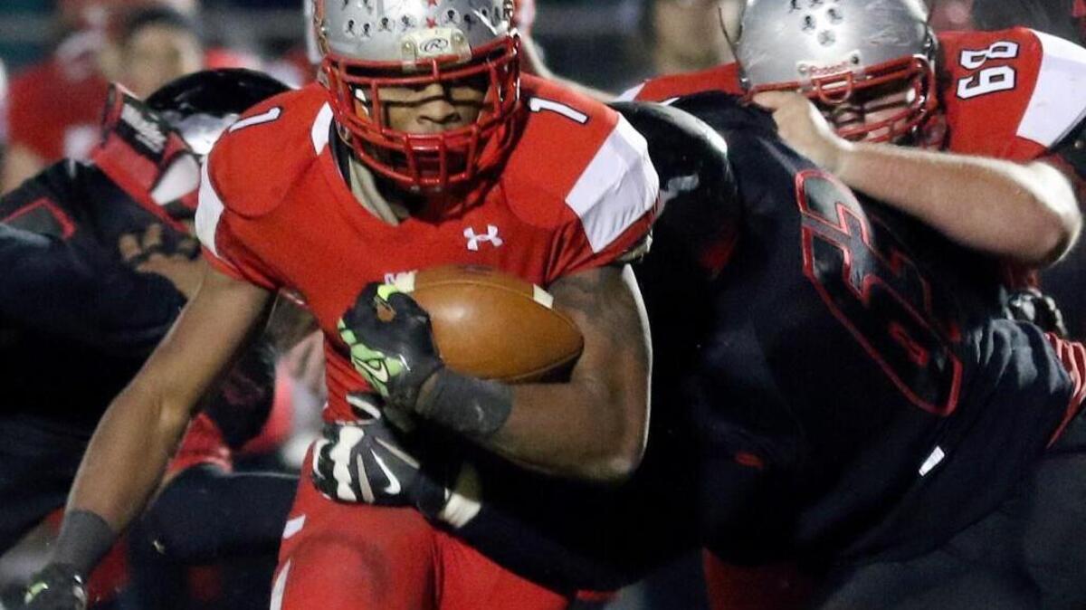 Greensboro Page's Javon Leake (1) breaks off tackle for a short gain but scored the first two Pirate touchdown. Coverage from the Eastern Regional 4AA NCHSAA Football Championship game between the Middle Creek Mustangs and the Greensboro Page Pirates played in Apex, N.C. on Friday, December 04, 2015. Greensboro Page leads at the half 21-10.